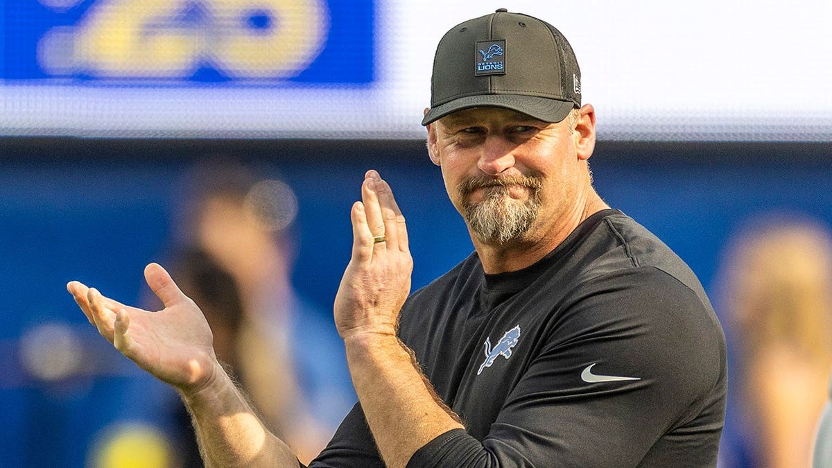 Dan Campbell cheers on the field during pregame warmups at SoFi Stadium.