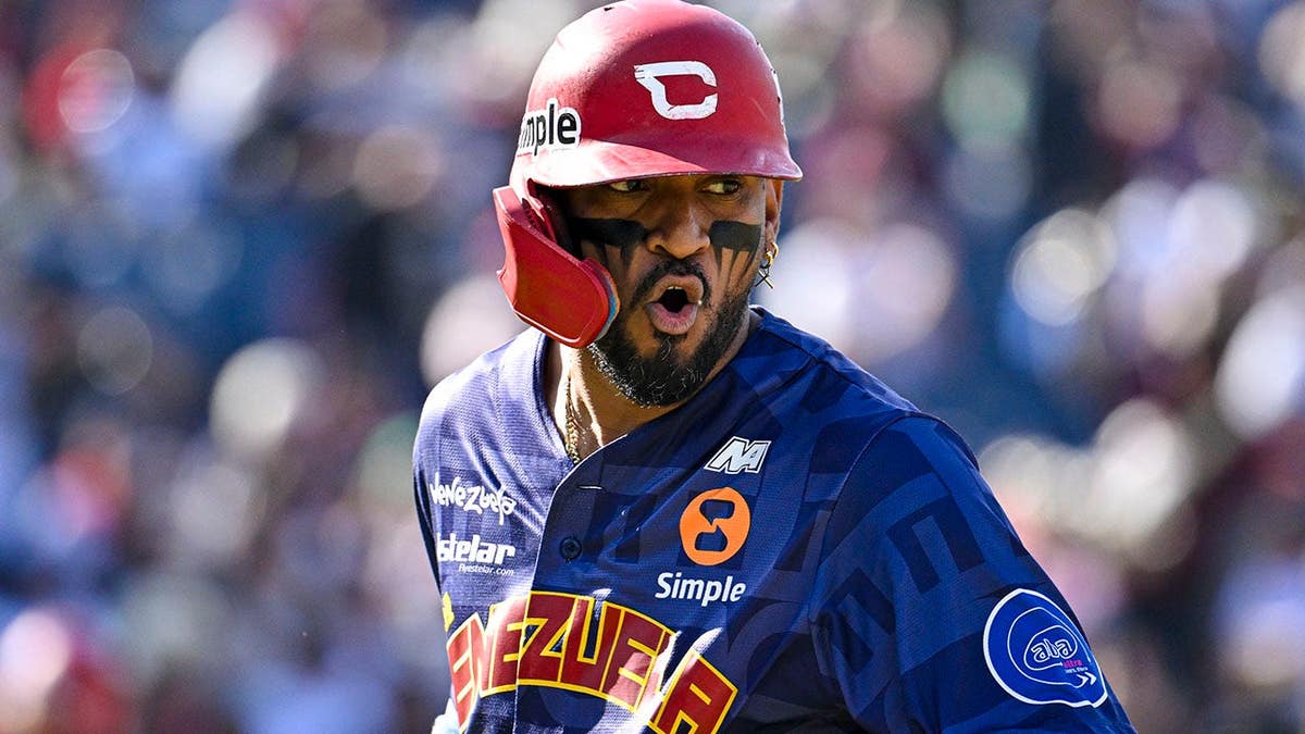 Danry Vasquez celebrates after hitting a home run during a baseball game.