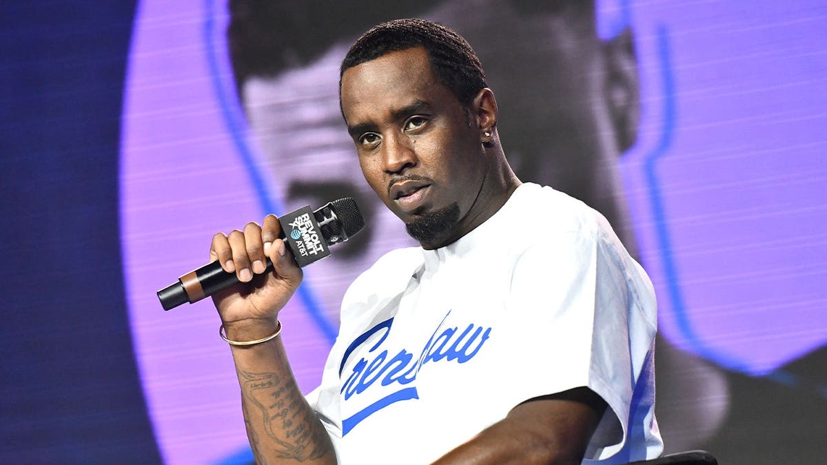 Sean Diddy Combs holds a microphone