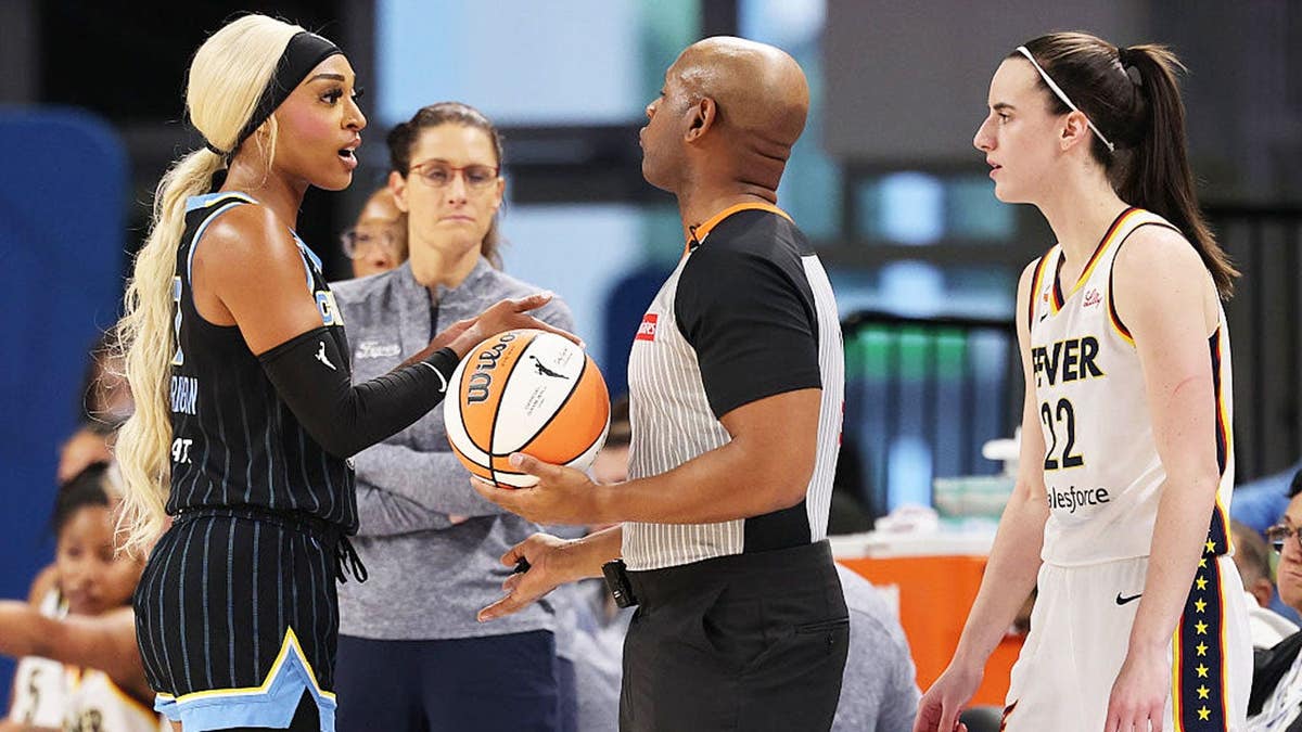 DiJonai Carrington #7 argues with a referee about Caitlin Clark #22 during a basketball game.