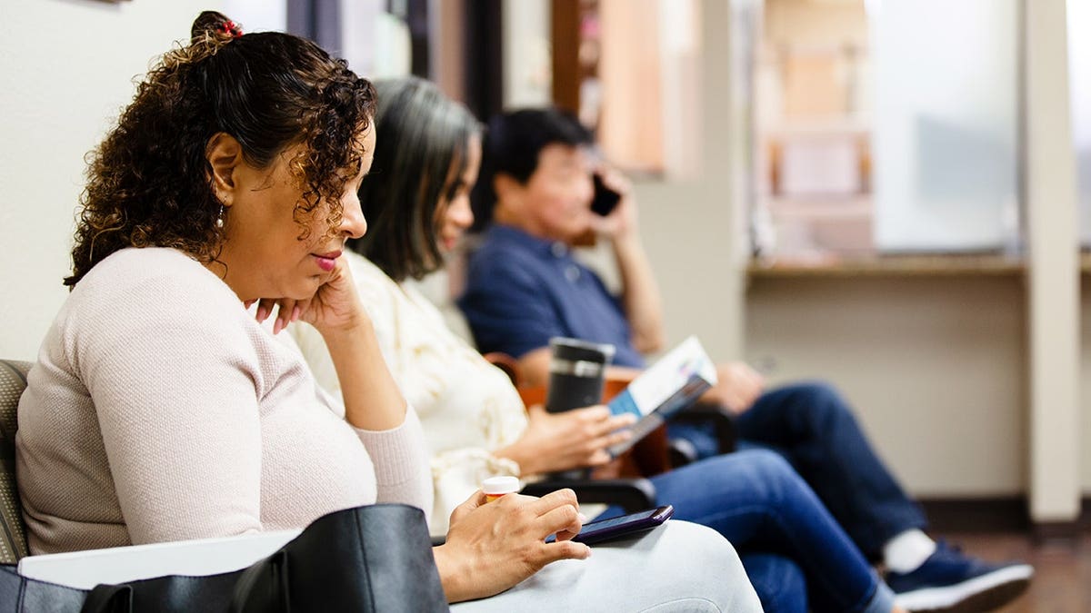 People sit in a doctor's waiting room