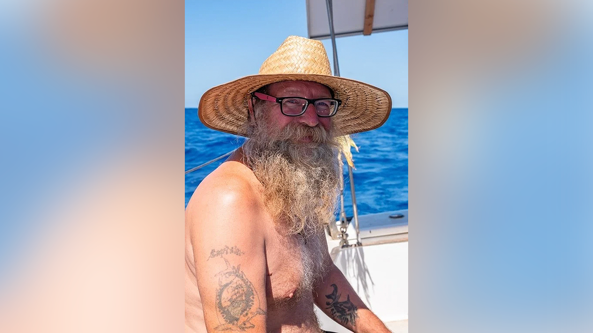 Donald Steven Lang aboard a sailboat wearing a straw hat