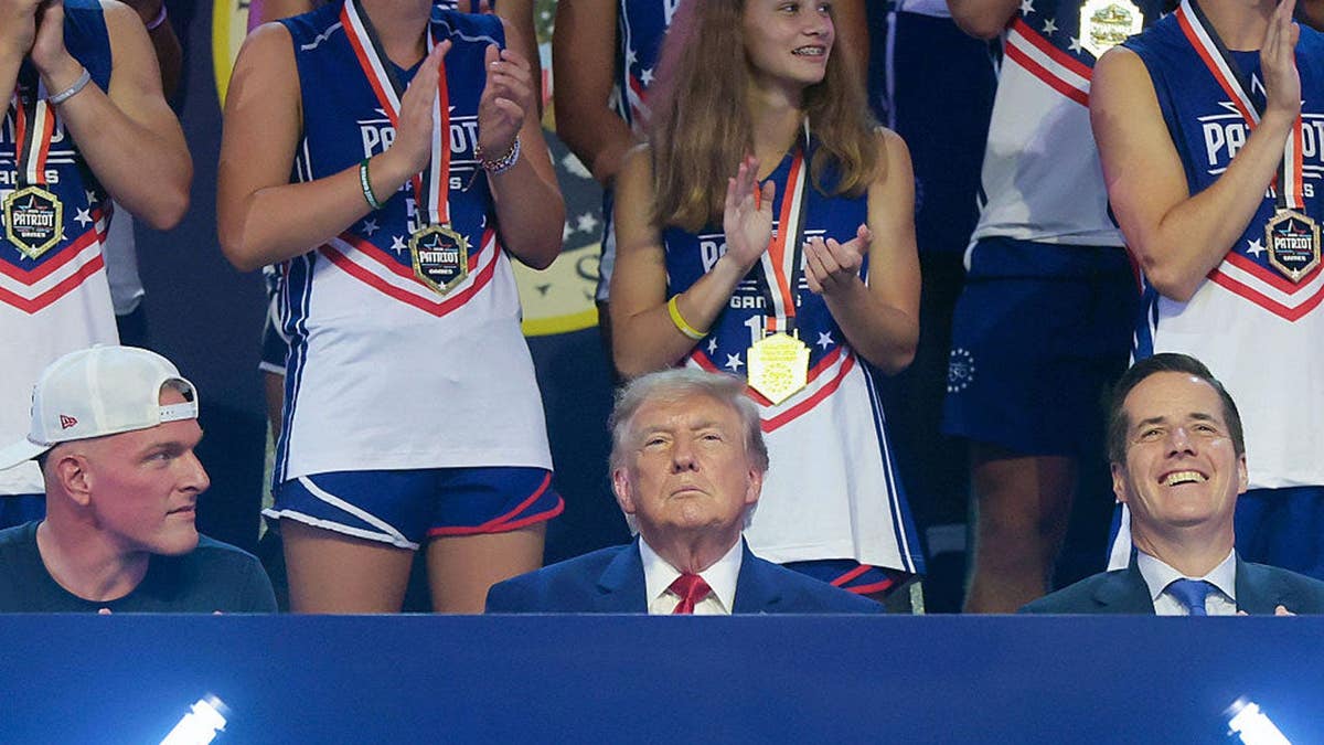Donald Trump sits next to Pat McAfee at the Patriot Games in Geneva, Ohio.