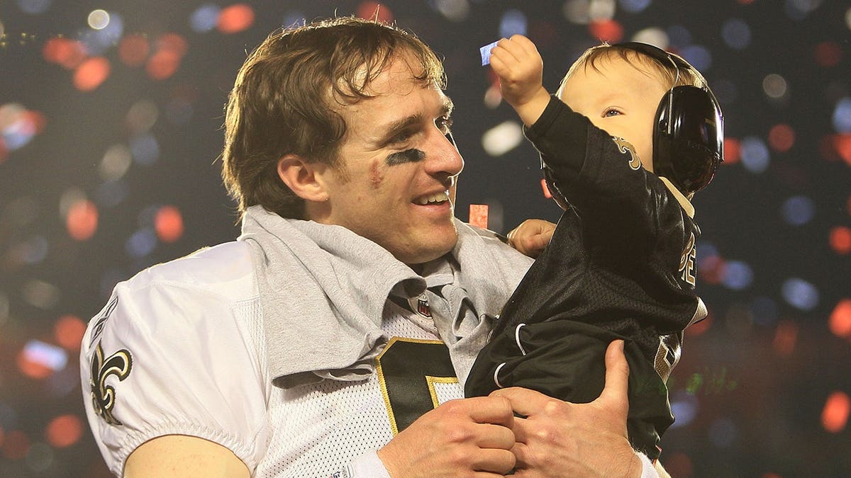 Drew Brees celebrates with his son Baylen after winning Super Bowl XLIV.