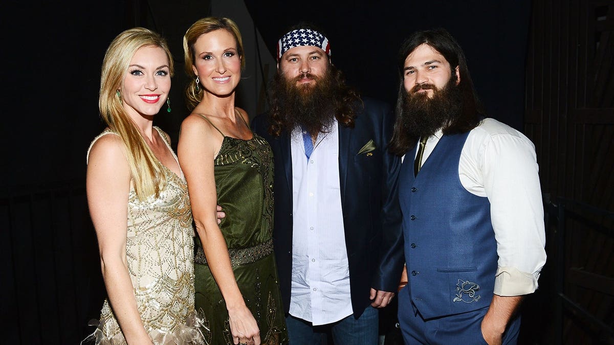 Jessica Robertson, Korie Robertson, Willie Robertson and Jep Robertson stand together at an event.