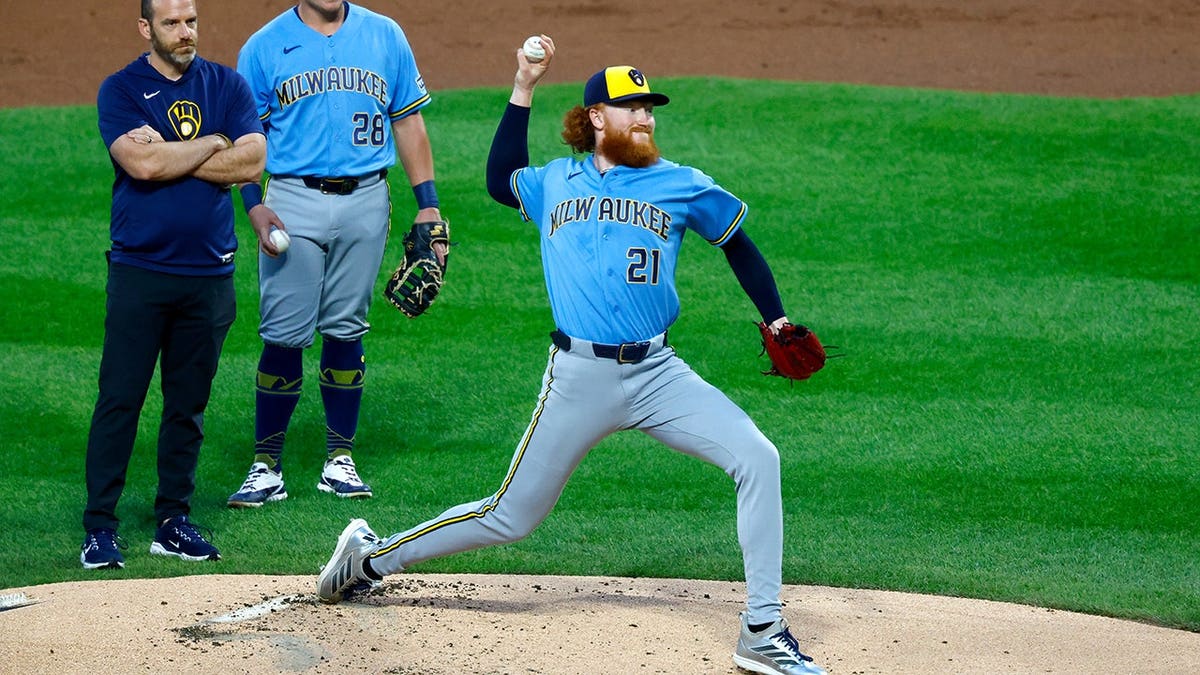 Dustin May throws after being hit by a batted ball during a baseball game.