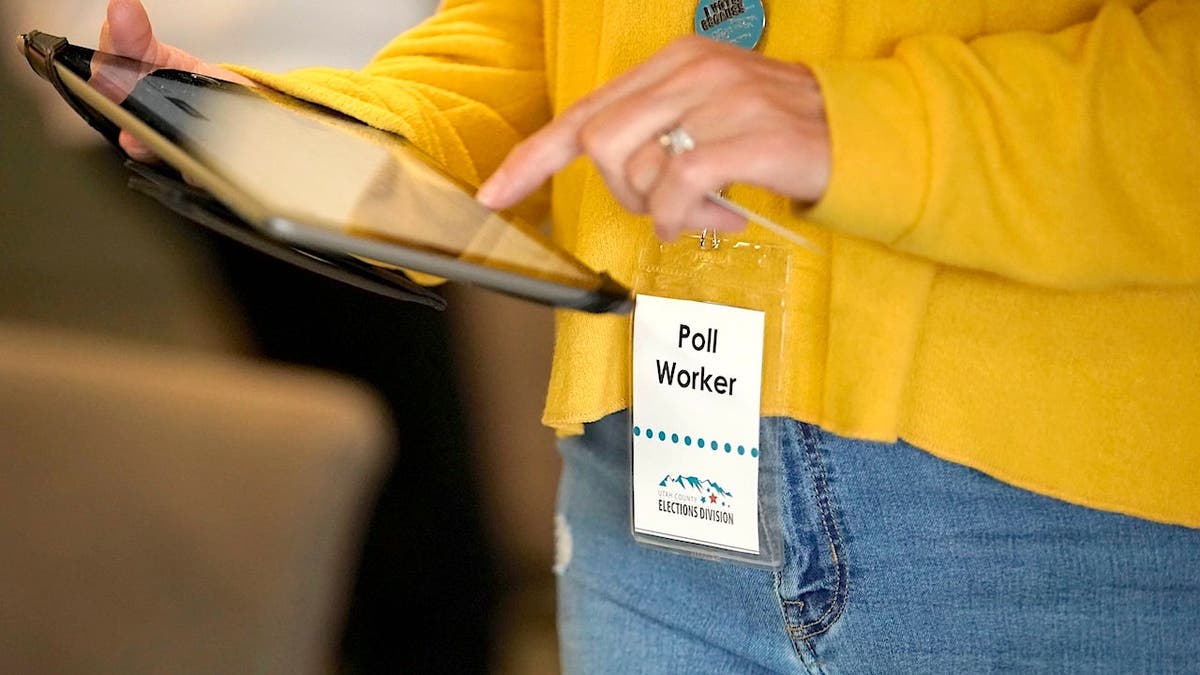 Poll worker checks in a voter at Center Point Church.