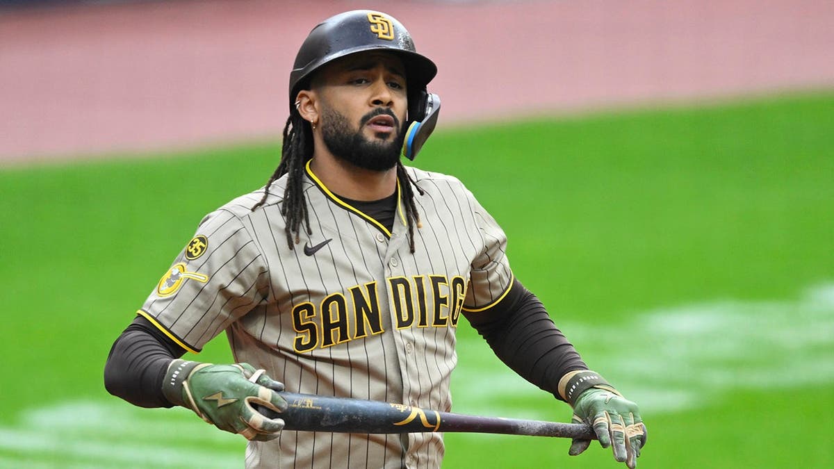 Fernando Tatis Jr. reacts after walking during a baseball game.