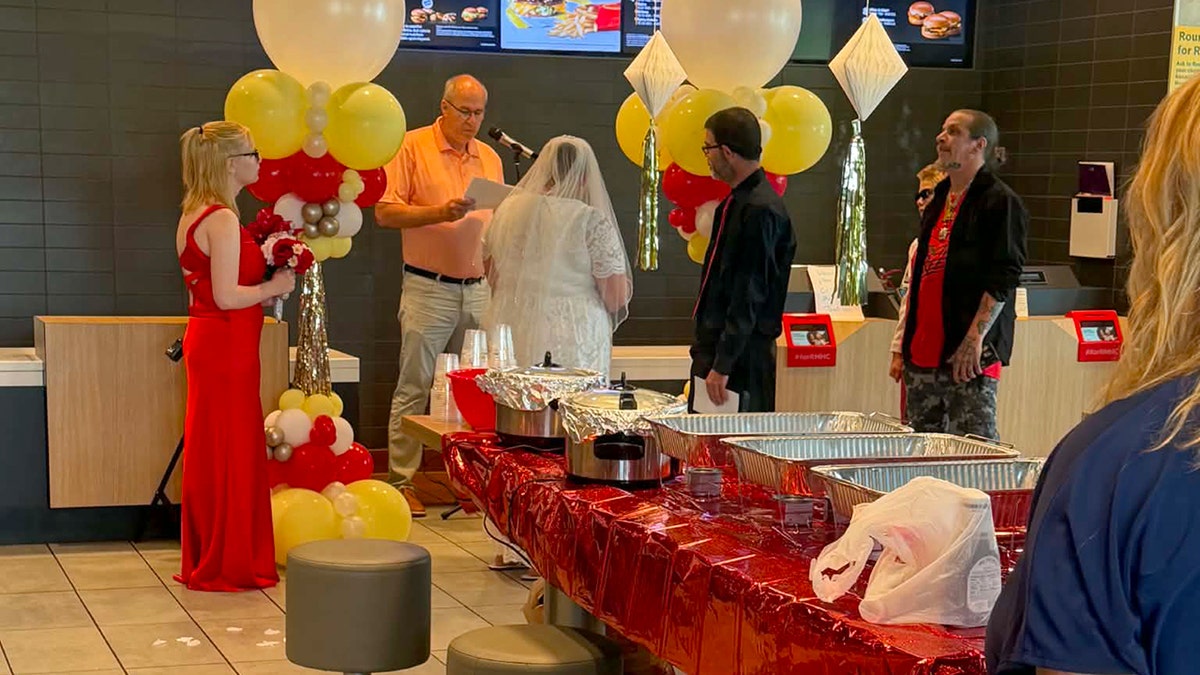 A wedding ceremony is held inside a McDonald's restaurant.