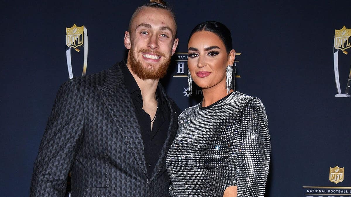 George Kittle and Claire Kittle walk on the red carpet at NFL Honors in Phoenix.