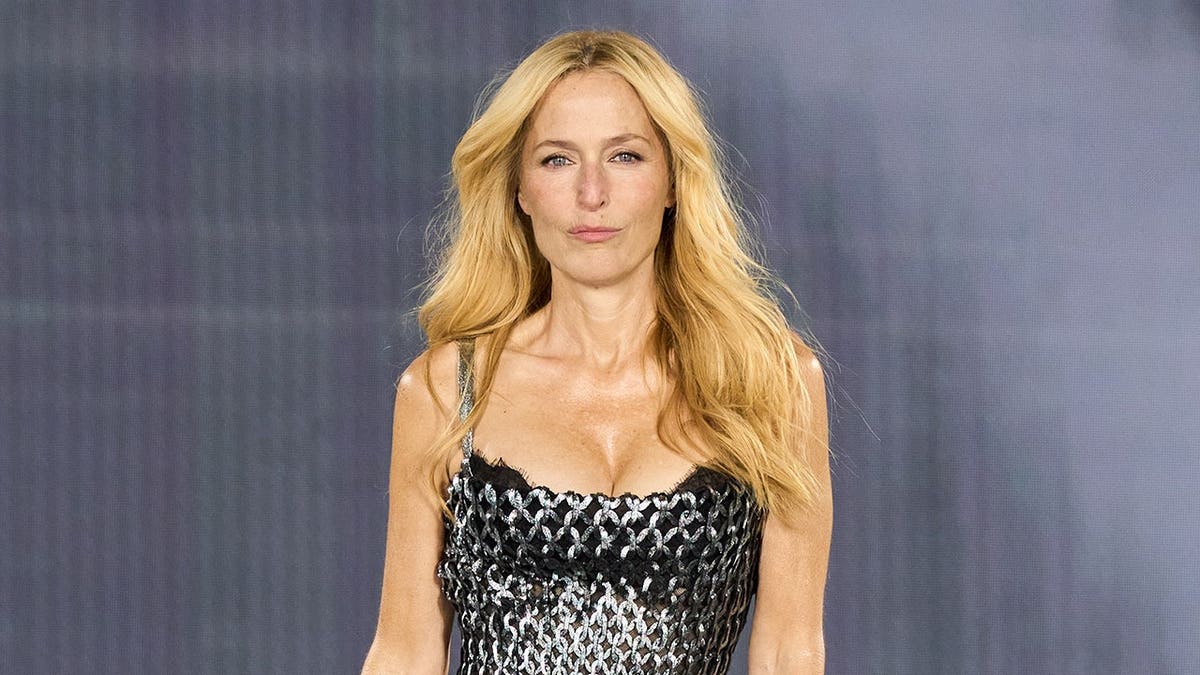 Gillian Anderson walks the runway in a L'OrÃ©al Paris show during Paris Fashion Week.