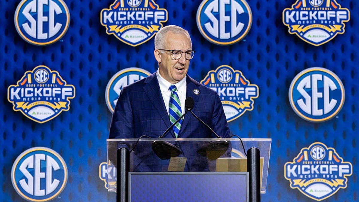 Greg Sankey speaks at a podium during SEC Football Media Day.