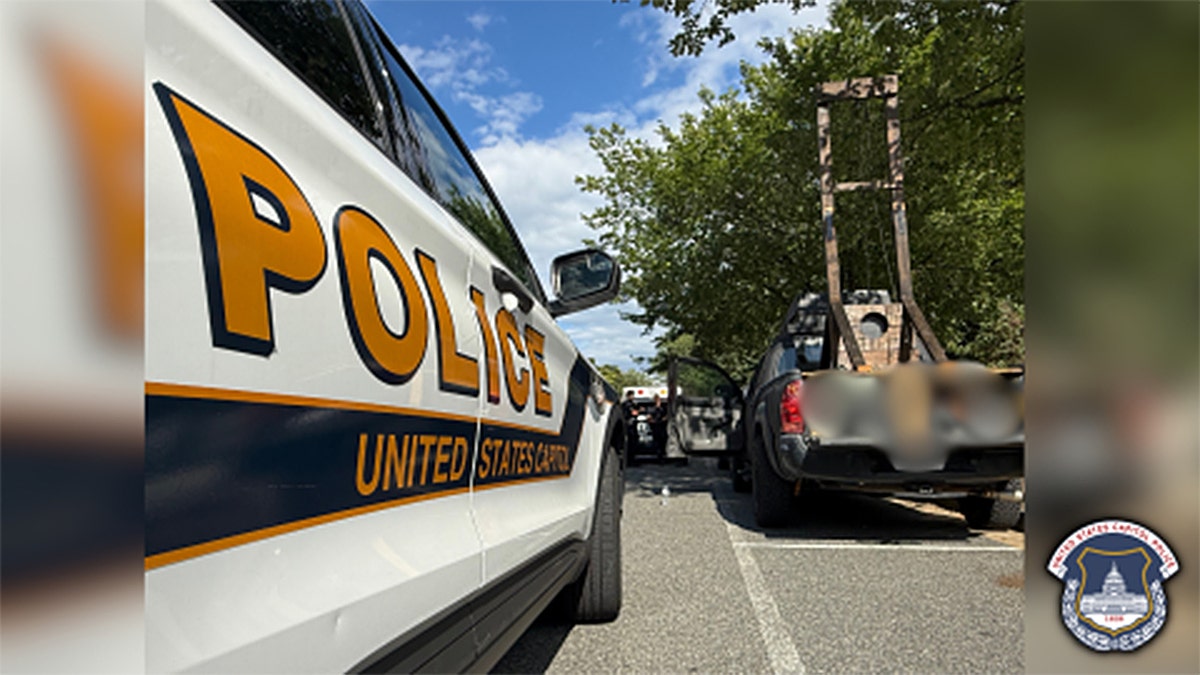 police car next to parked car with guillotine
