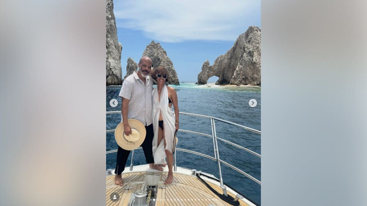 Halle Berry and Van Hunt hugging while on a yacht together.