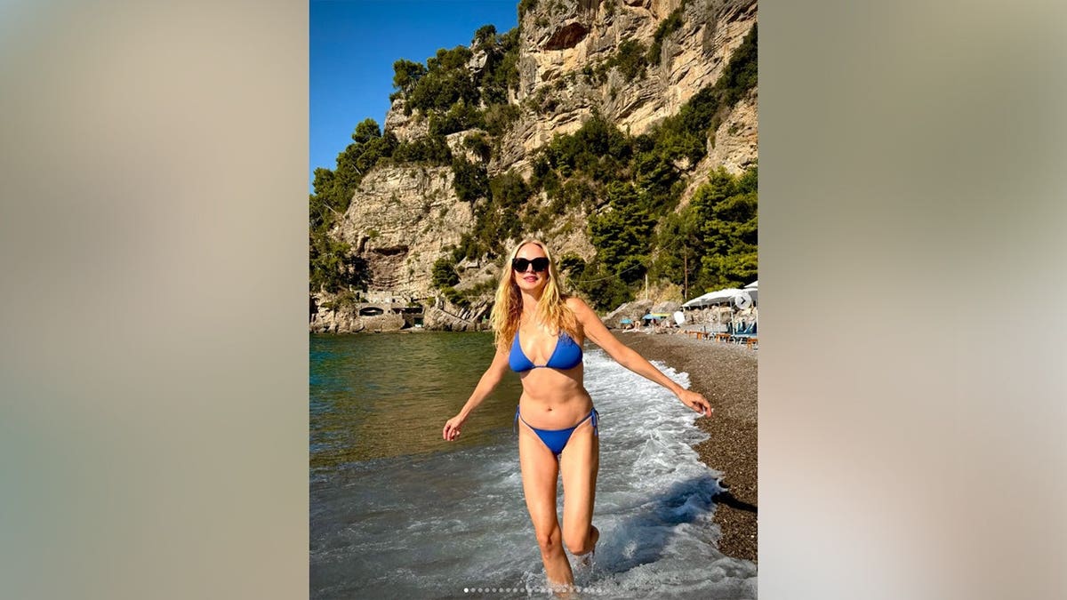 Heather Graham wearing a blue bikini while on vacation in Positano.