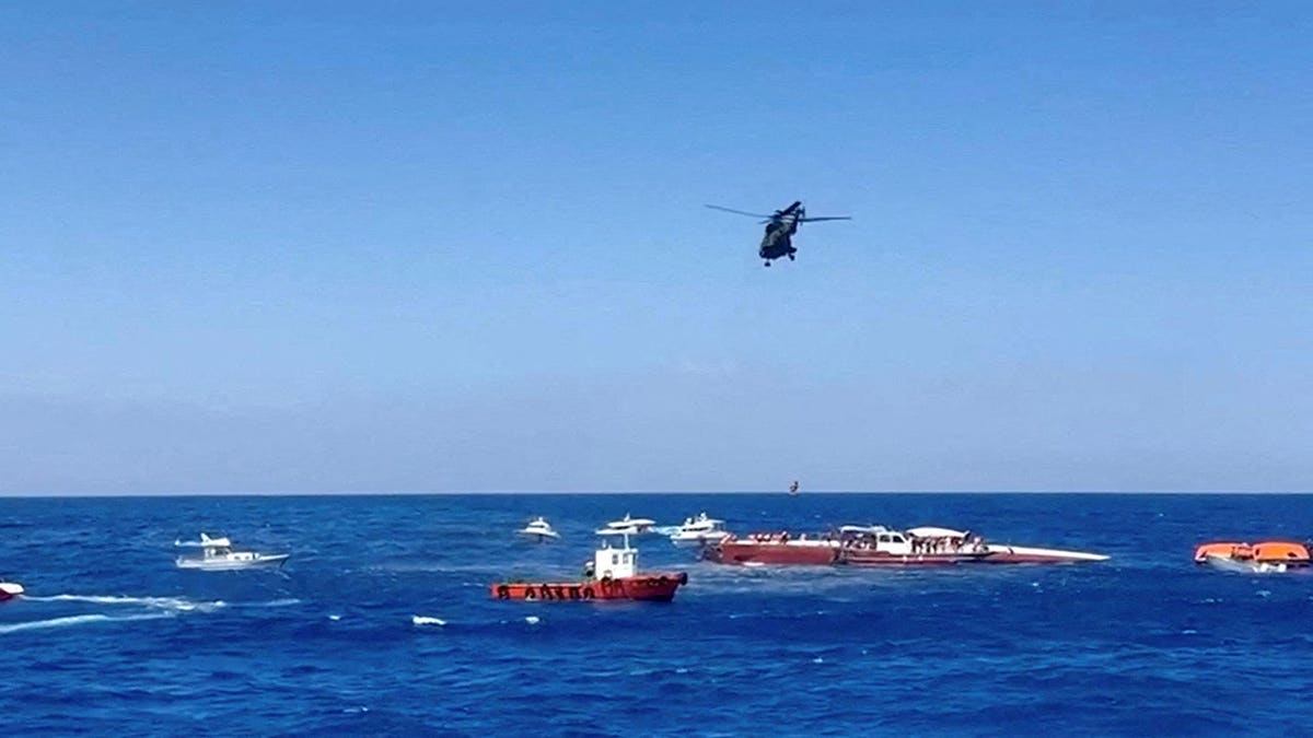 A helicopter rescues a passenger from a capsized ferry off Northern Cyprus.