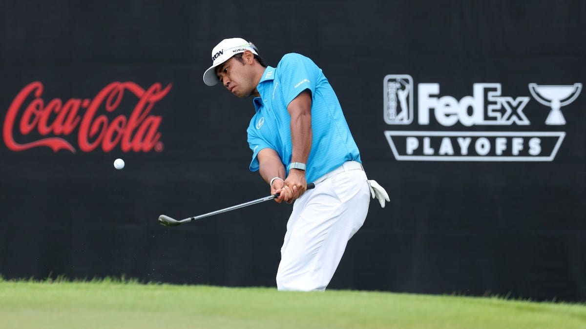 Hideki Matsuyama chips onto the seventh green during the 2025 TOUR Championship at East Lake Golf Club in Atlanta, Georgia.