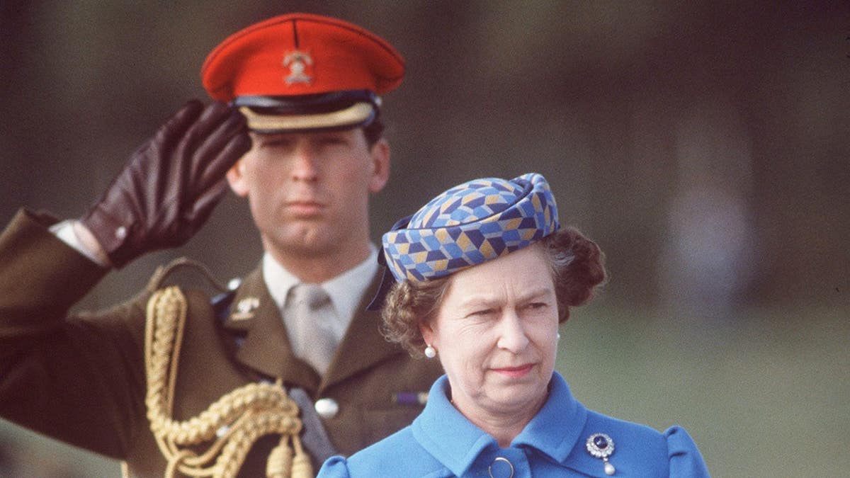 Queen Elizabeth stands with Major Hugh Lindsay during an official tour of Portugal.