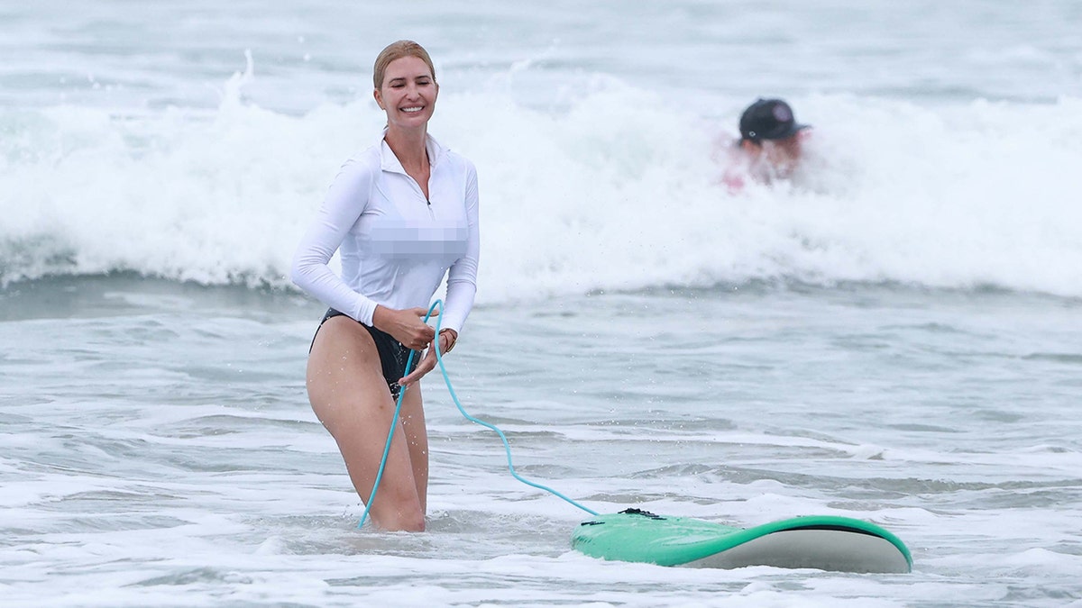 Ivanka Trump stood in the water as she waited for the next wave to come.