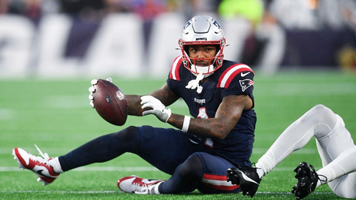 Ja'Lynn Polk #1 of the New England Patriots gets a first down during a preseason game.