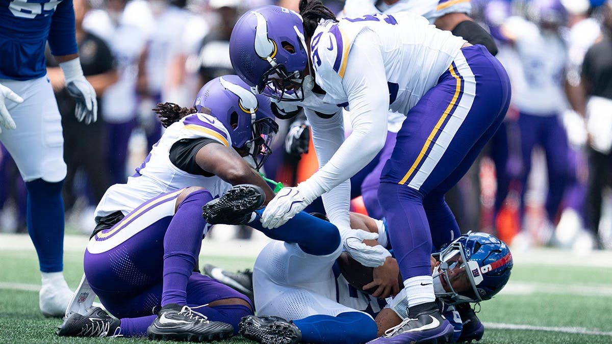 Jaxson Dart, New York Giants quarterback, is sacked during a preseason game.