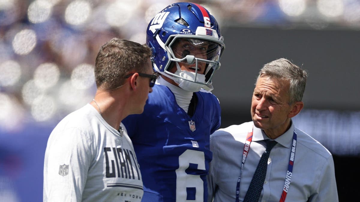Jaxson Dart is helped off the field after being sacked during an NFL preseason game.