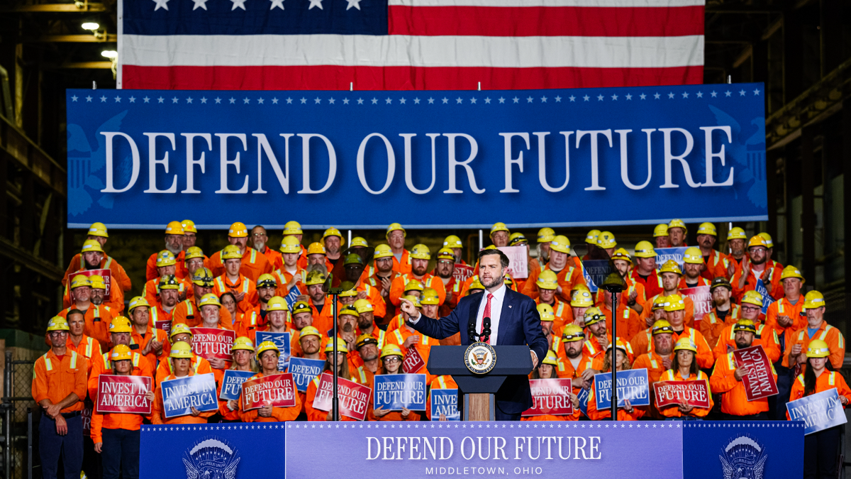JD Vance stands at a podium during Middletown speech