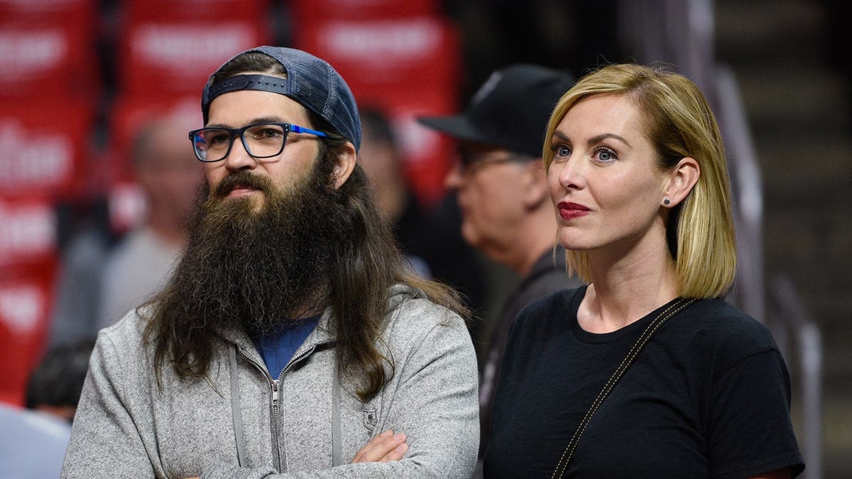 Jep Robertson and Jessica Robertson seated at a basketball game.
