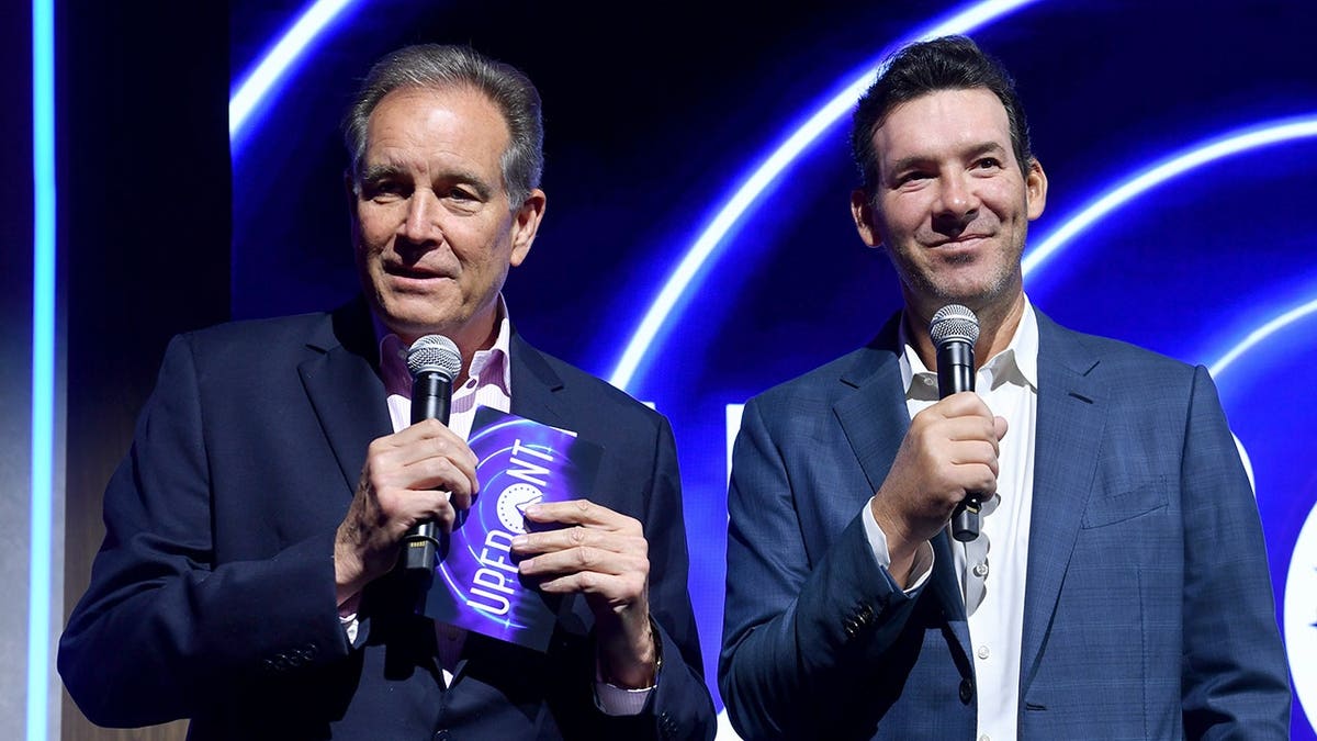 Jim Nantz and Tony Romo speak on stage during an event in New York City.