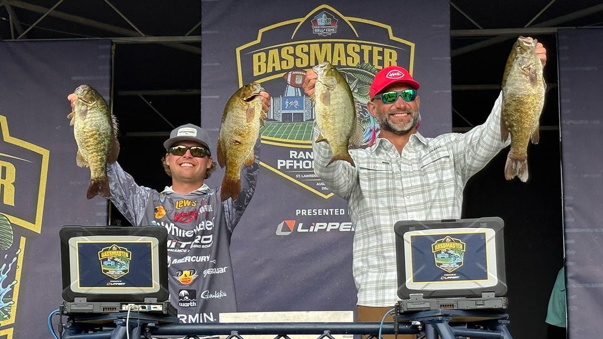 Joe Thomas and Jay Przekurat hold up their fish on stage