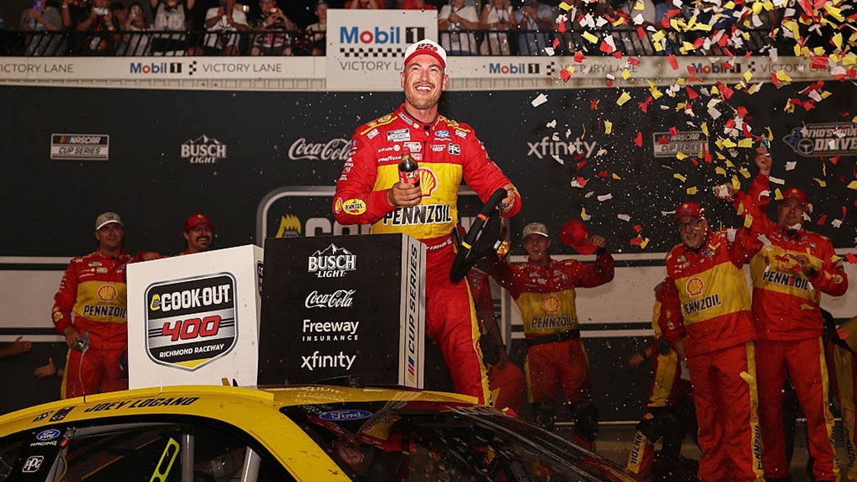 Joey Logano celebrates in victory lane after winning the NASCAR Cook Out 400 at Richmond Raceway.