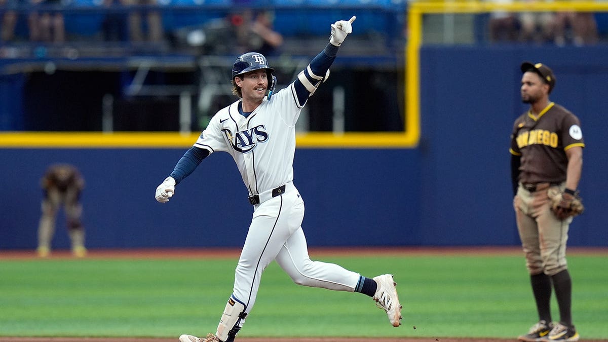 Jonny DeLuca celebrates after hitting a two-run home run during a baseball game.