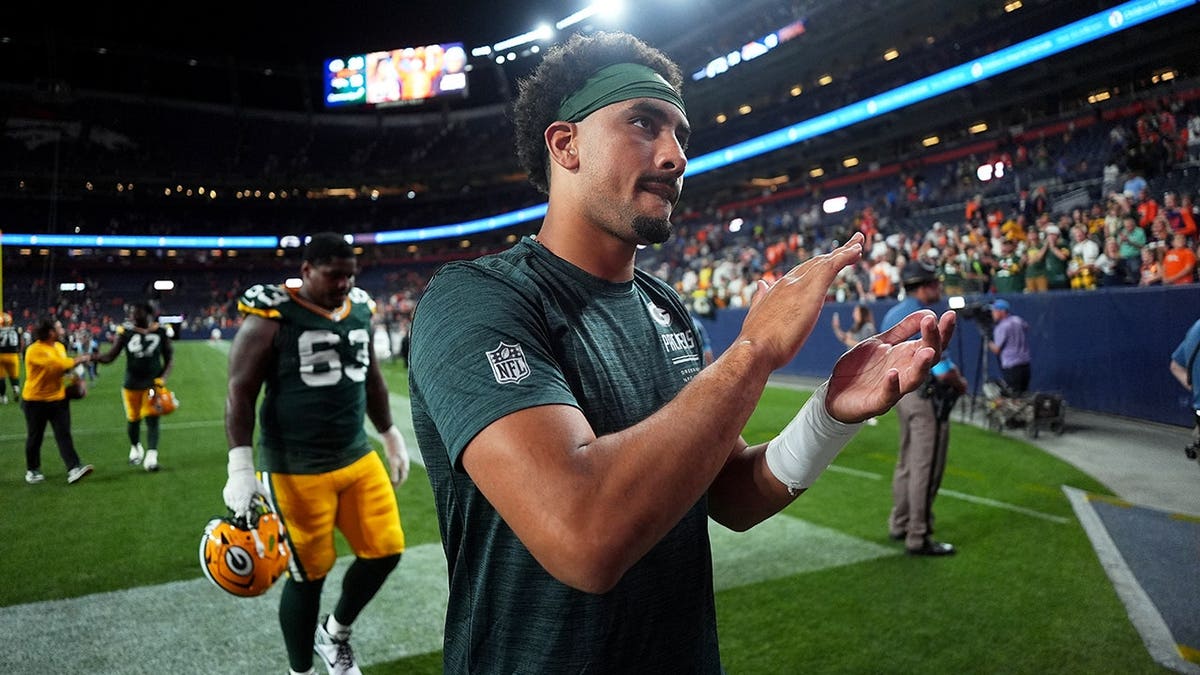 Jordan Love walks off the field after an NFL preseason game.
