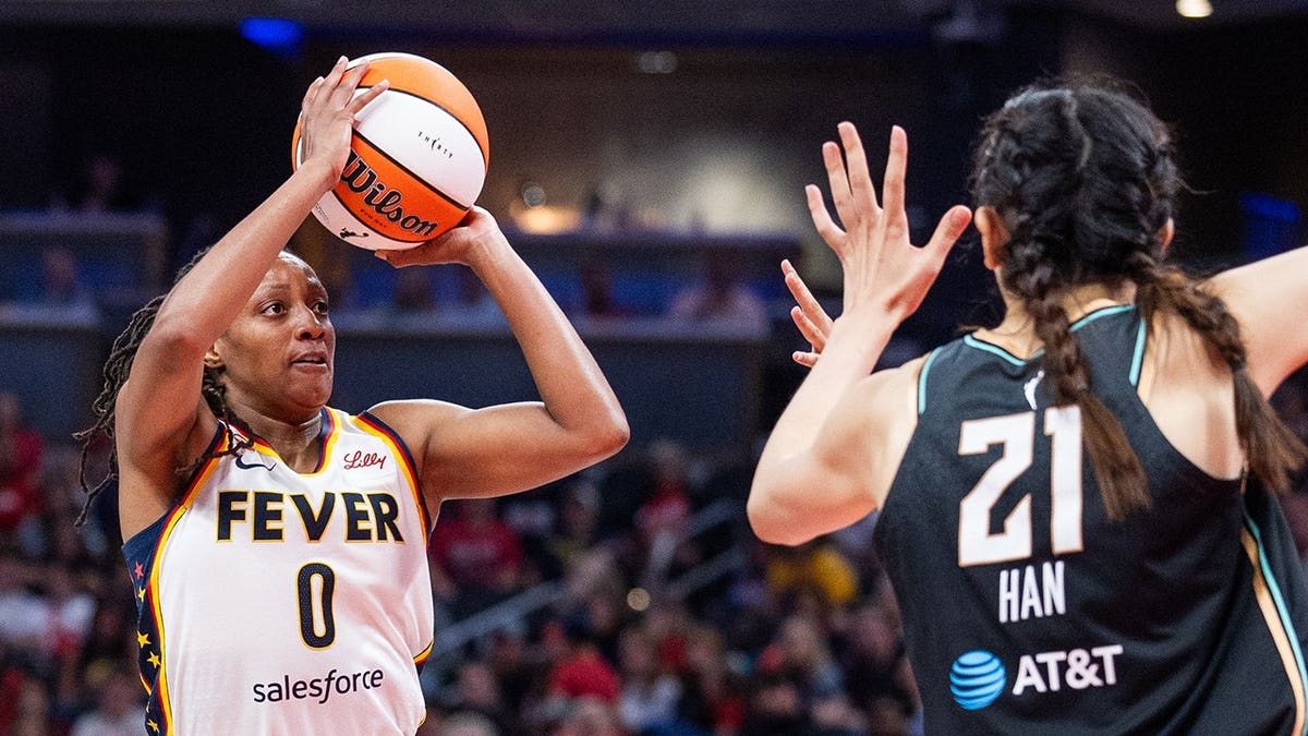 Kelsey Mitchell shoots the ball during a WNBA game.
