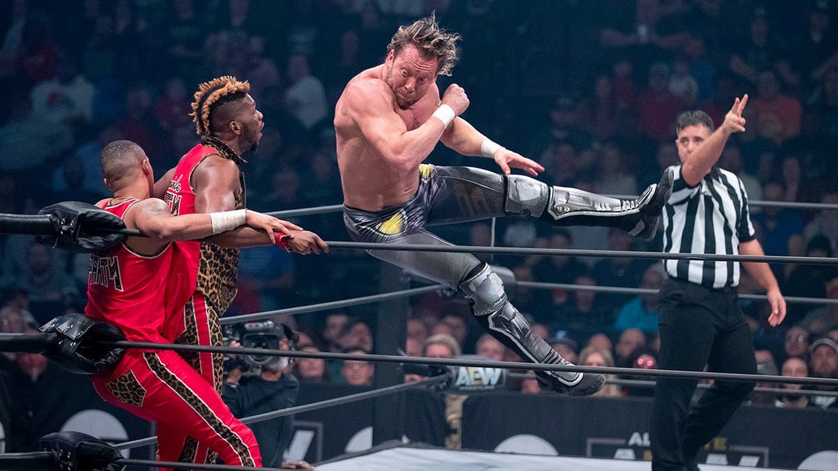 Kenny Omega and Adam Page wrestle against Private Party in a tag-team match.