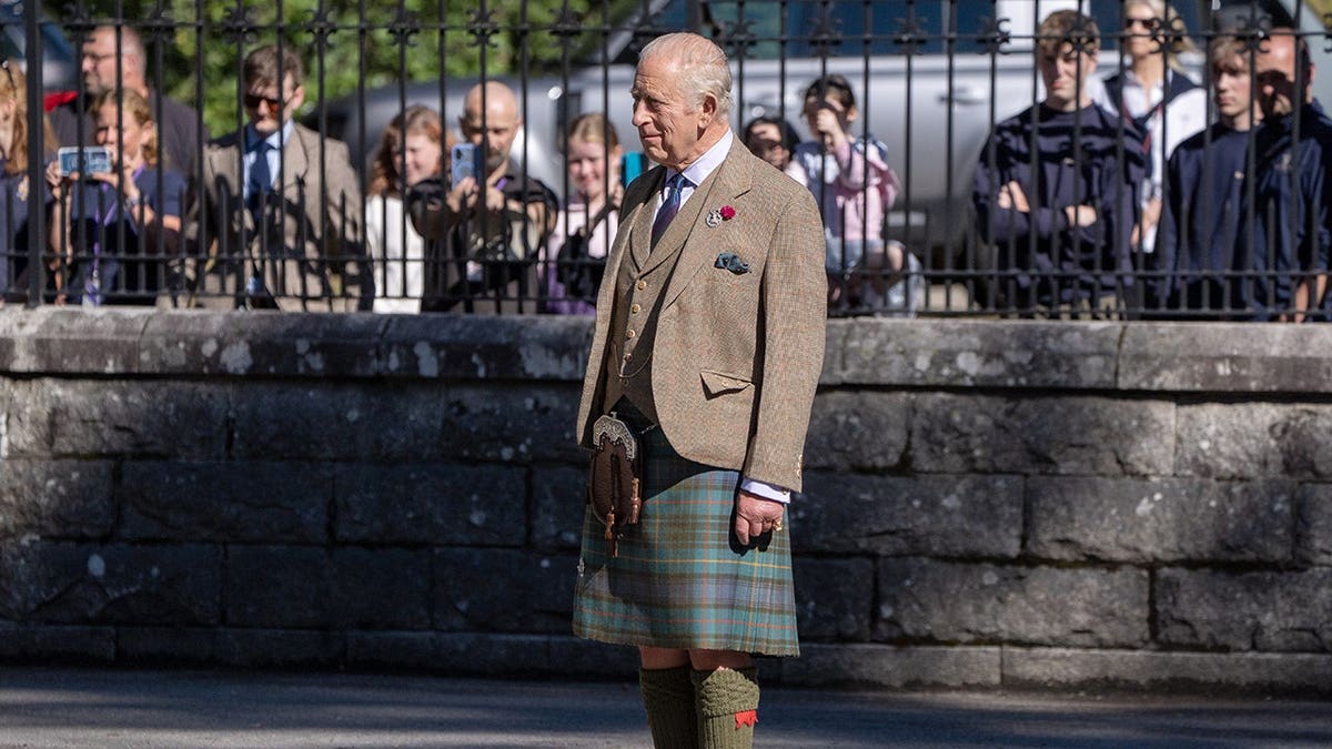 King Charles III inspects soldiers at the gates of Balmoral.