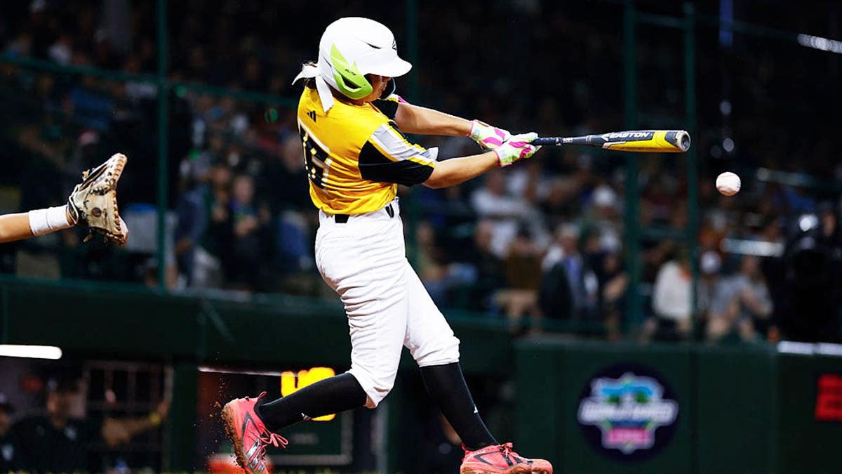 Kinley Rasmus hits a single during the Little League World Series game.