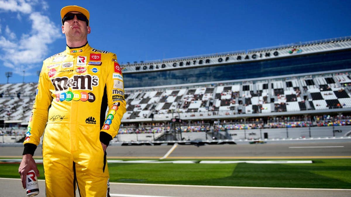 Kyle Busch stands on the grid during NASCAR Daytona 500 qualifying at Daytona International Speedway.