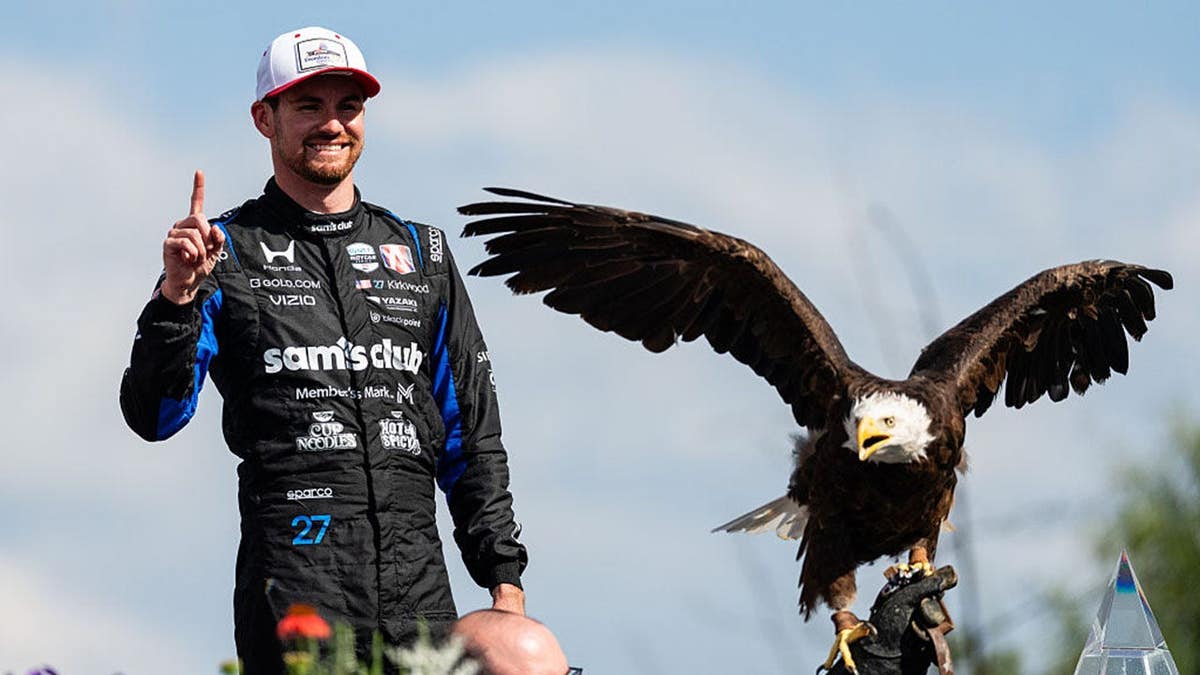Kyle Kirkwood poses with a bald eagle in Washington, D.C.