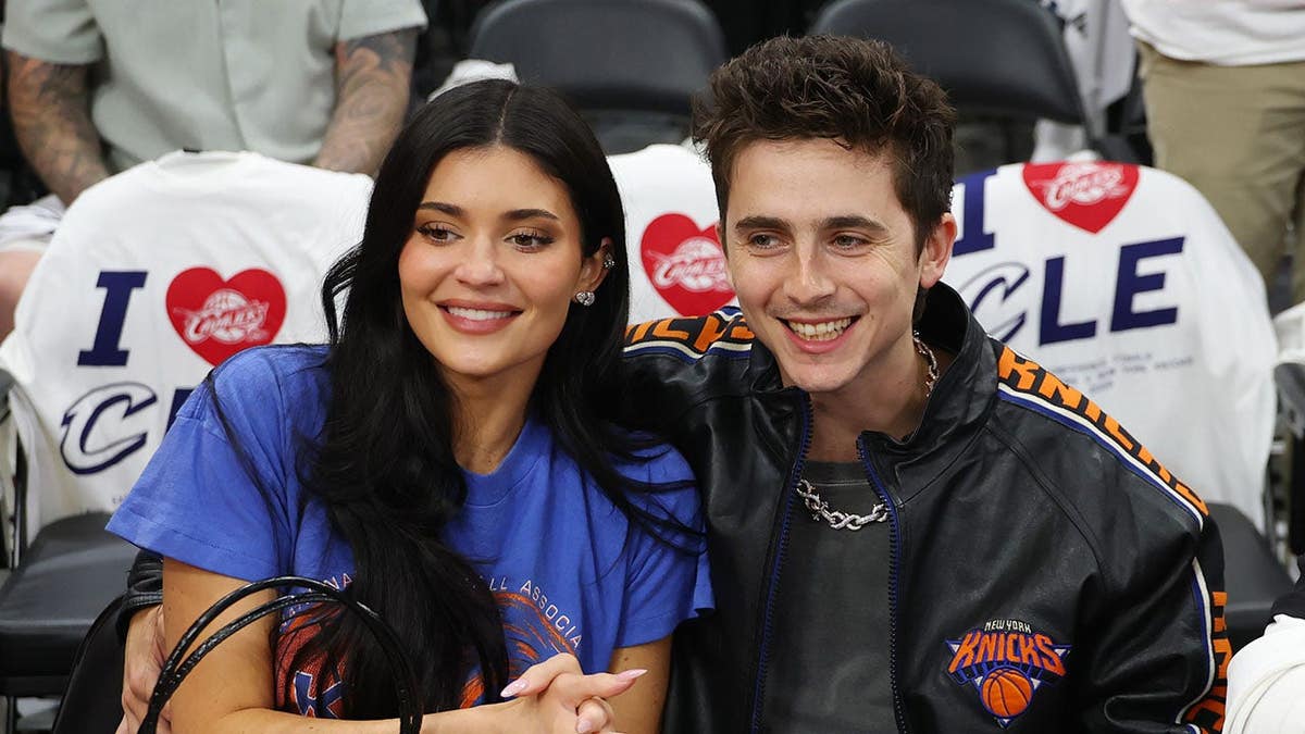 Kylie Jenner and Timothée Chalamet seated at an NBA Eastern Conference Finals game.