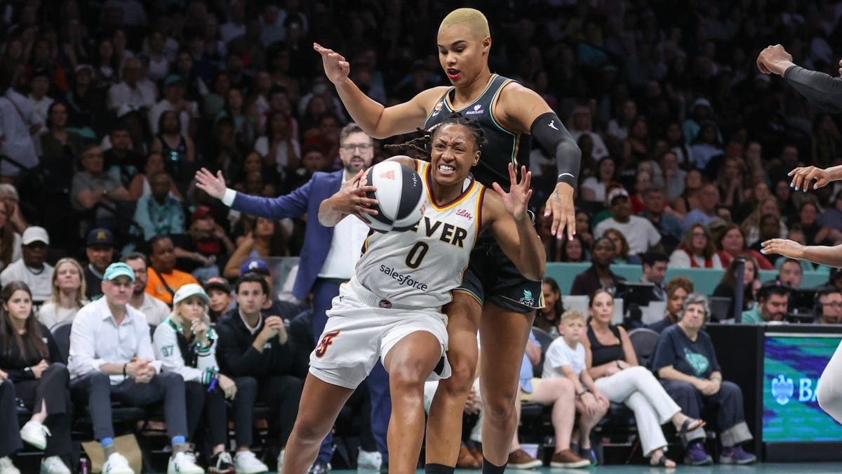 Indiana Fever All-Star Kelsey Mitchell drives past New York Liberty forward Satou Sabally at Barclays Center in Brooklyn.