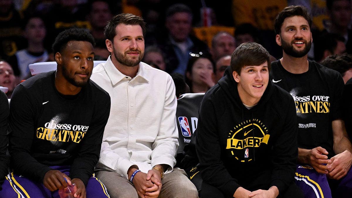 Luka Doncic, Bronny James, Austin Reeves and Maxi Kleber look on during an NBA playoff game.