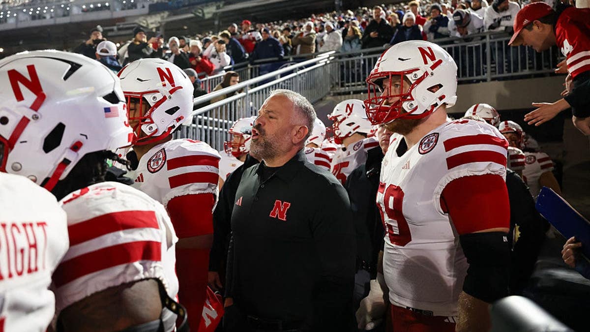 Matt Rhule leads Nebraska Cornhuskers players onto the field at Beaver Stadium.