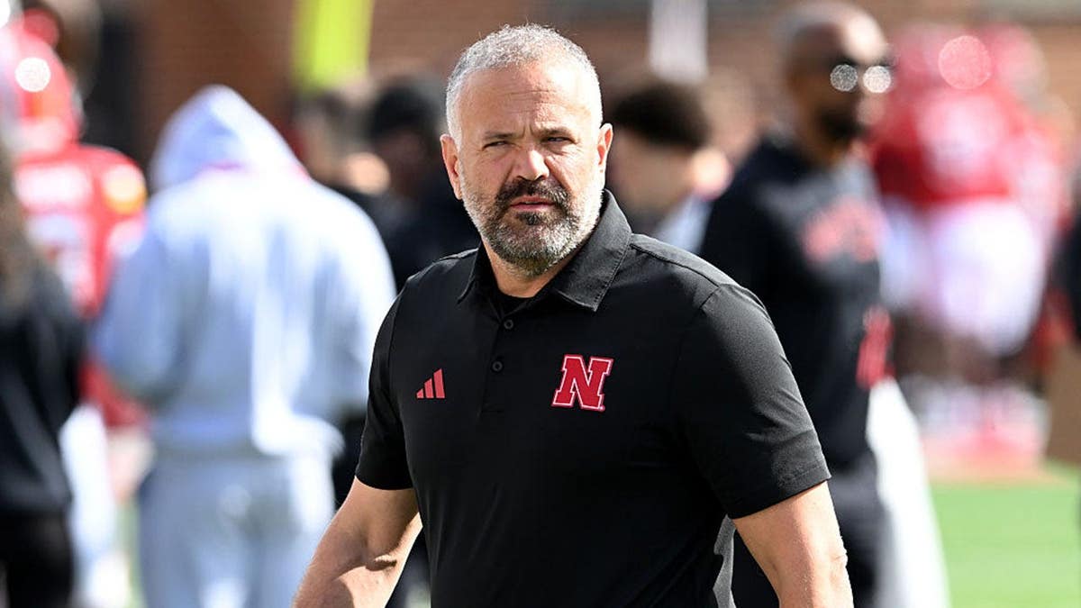 Matt Rhule watches Nebraska and Maryland warm up before a football game.