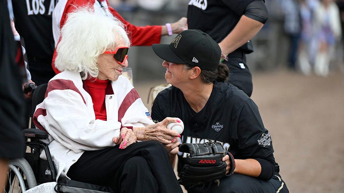 Maybelle Blair and Elodie O'Sullivan stand together before a Women's Professional Baseball League game.