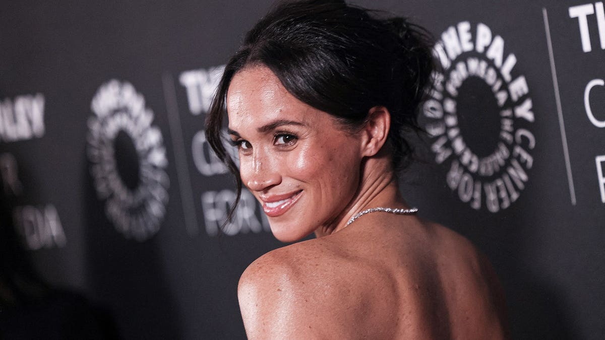 Meghan, Duchess of Sussex arrives at a red carpet gala event.