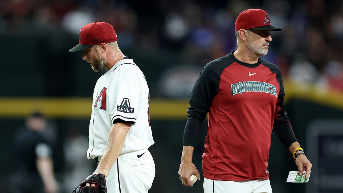 Merrill Kelly #29 is removed by Arizona Diamondbacks manager Torey Lovullo #17 during an MLB game.