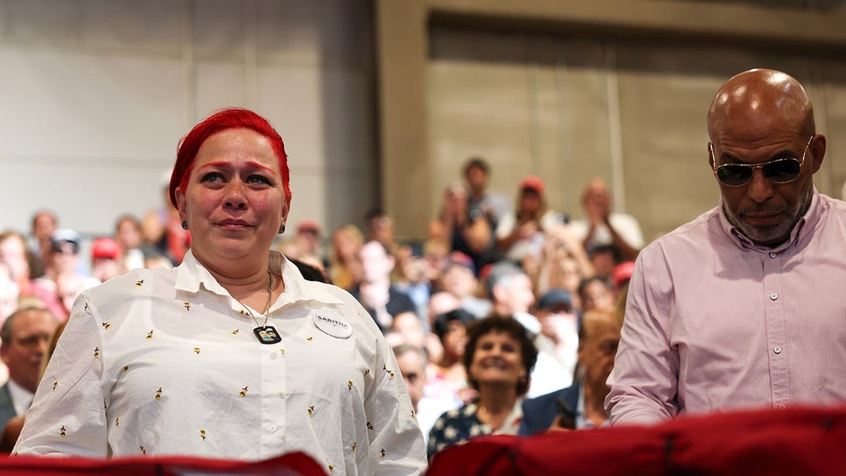 Migdalia Martinez reacts as President Trump recognizes her at an event in Garden City, New York.