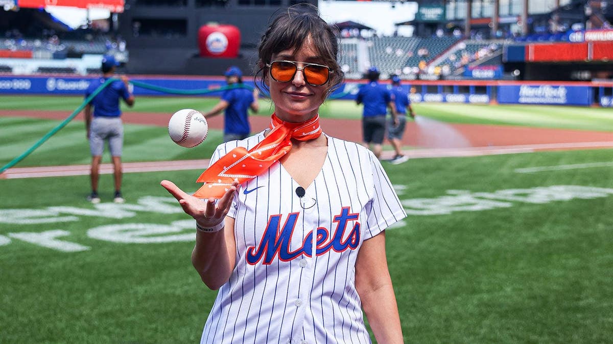 Milana Vayntrub poses for a photo before delivering the ceremonial first pitch at Citi Field.