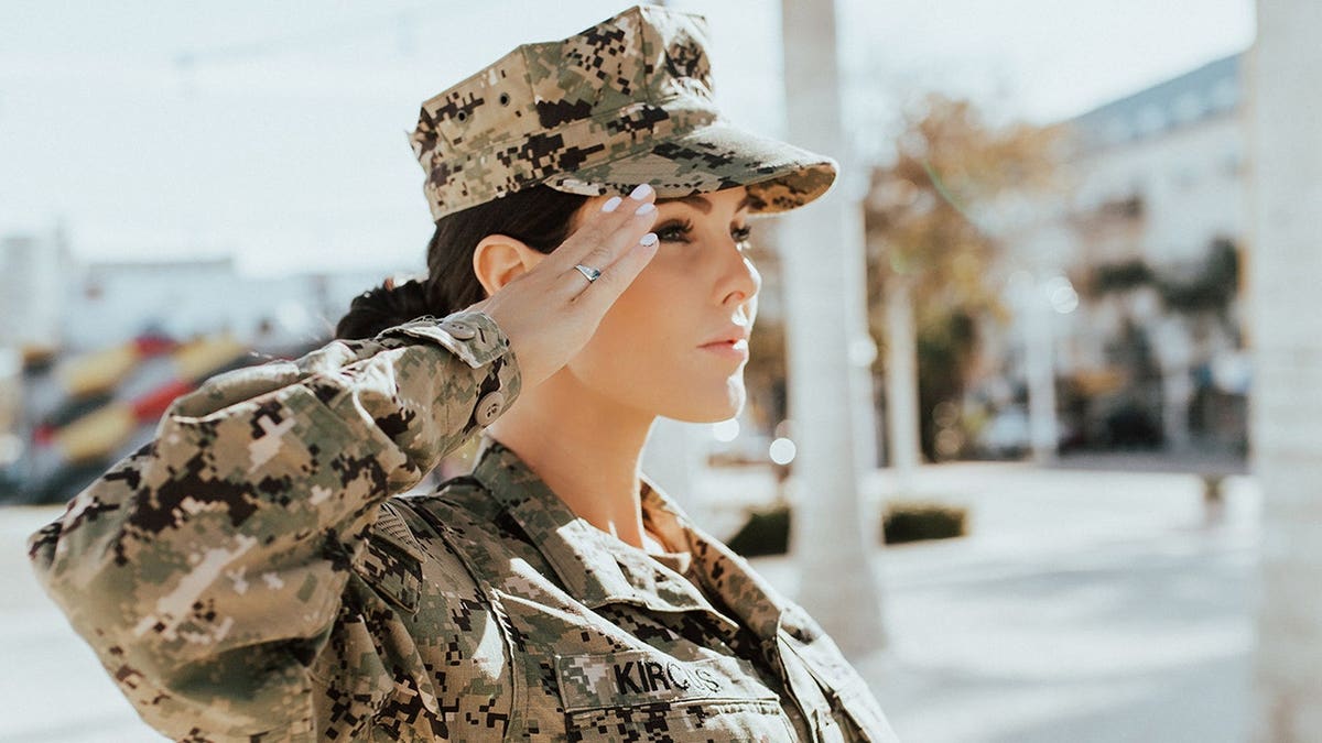 Jade Kircus in uniform making a salute.